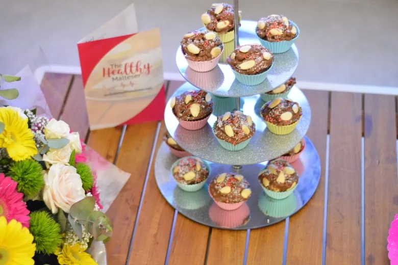 A Cake stand packed with chocolate muffins topped with a luscious healthy vegan frosting
