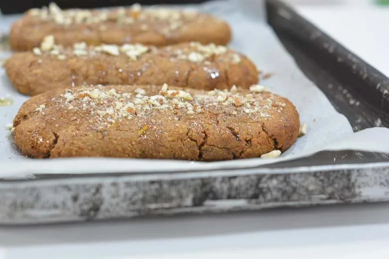 A tray with Maltese Kwarezimal topped with agave syrup and chopped almonds