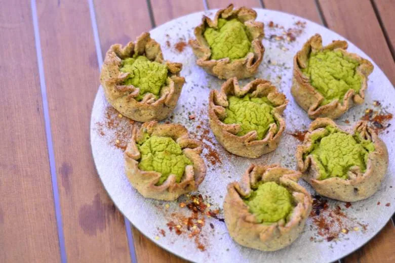 A plate of Vegan Qassatat tal-Pizelli on a wooden table