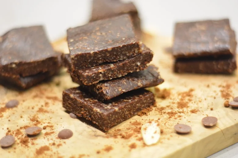 quick and easy no bake brownie squares on a wooden board