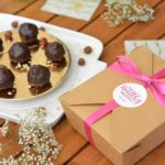 Healthy Baci placed next to a 'Healthy Malteser' Parcel box with a pink ribbon