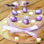 Healthy Carrot Cake topped with Vegan Cream Cheese frosting and decorated in a purple ribbon