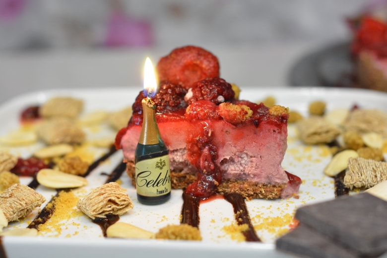 Strawberry Cheesecake slice with Champagne Bottle Candle