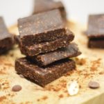 quick and easy no bake brownie squares on a wooden board